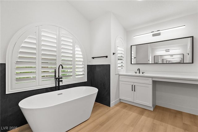 1990 Freeman Ct, Henderson, NV 89014 - bathroom with wood finished floors, a freestanding tub, and vanity