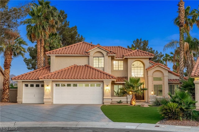 1990 Freeman Ct, Henderson, NV 89014 - mediterranean / spanish-style house featuring driveway, an attached garage, stucco siding, a tiled roof, and a front yard
