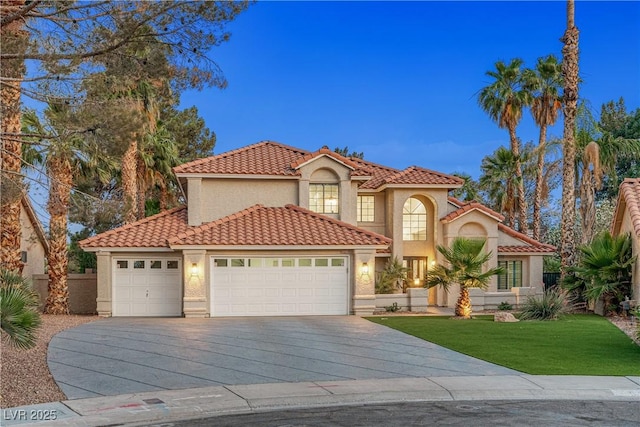 1990 Freeman Ct, Henderson, NV 89014 - mediterranean / spanish-style house with concrete driveway, stucco siding, a tile roof, an attached garage, and a front lawn