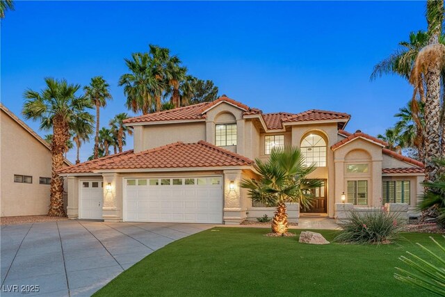 1990 Freeman Ct, Henderson, NV 89014 - mediterranean / spanish-style home with stucco siding, concrete driveway, a tiled roof, a front yard, and a garage