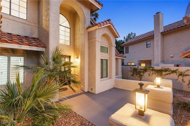 1990 Freeman Ct, Henderson, NV 89014 - view of exterior entry with a tile roof, stucco siding, and a patio