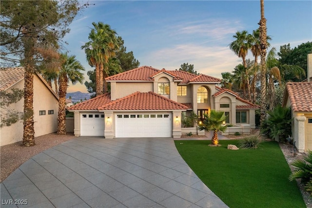 1990 Freeman Ct, Henderson, NV 89014 - mediterranean / spanish home with stucco siding, a tiled roof, a yard, a garage, and driveway