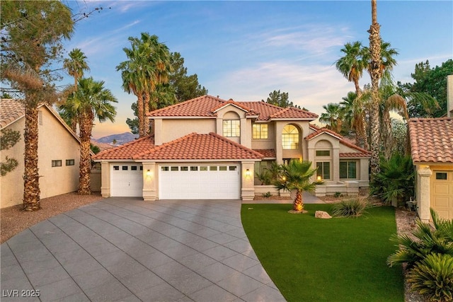 1990 Freeman Ct, Henderson, NV 89014 - mediterranean / spanish house featuring stucco siding, a yard, concrete driveway, an attached garage, and a tile roof