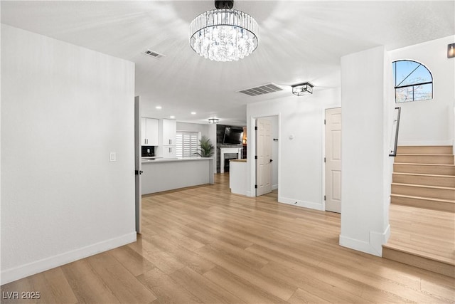 1990 Freeman Ct, Henderson, NV 89014 - unfurnished living room featuring plenty of natural light, stairway, light wood-style flooring, and recessed lighting