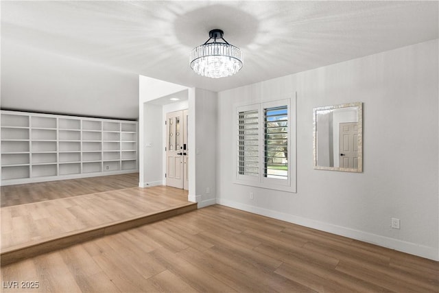 1990 Freeman Ct, Henderson, NV 89014 - unfurnished living room with wood finished floors and a chandelier