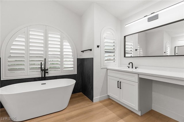 1990 Freeman Ct, Henderson, NV 89014 - bathroom with wood finished floors, a freestanding tub, and vanity