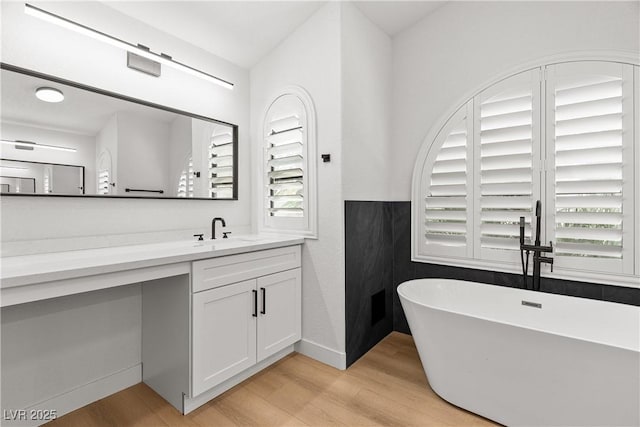 1990 Freeman Ct, Henderson, NV 89014 - full bath with wood finished floors, a freestanding bath, vanity, and plenty of natural light