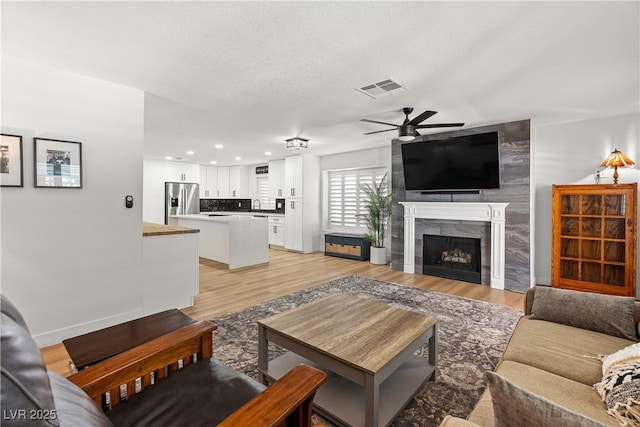 1990 Freeman Ct, Henderson, NV 89014 - living area featuring ceiling fan, light wood-type flooring, a fireplace, and recessed lighting