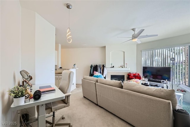7127 S Durango Dr Unit 310, Las Vegas, NV 89113 - living area with a ceiling fan, light colored carpet, a fireplace, and a desk