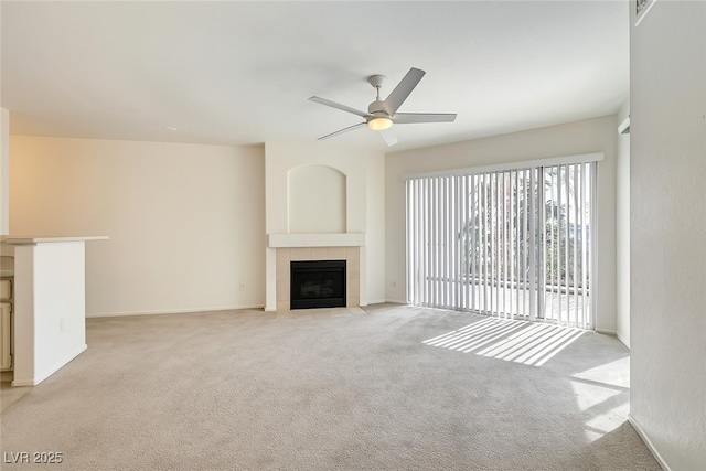 7127 S Durango Dr Unit 310, Las Vegas, NV 89113 - unfurnished living room featuring a tiled fireplace, light colored carpet, and ceiling fan