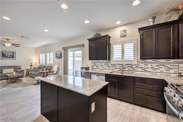 7948 Eastern Elk St, Las Vegas, NV 89149 - kitchen with a center island, tasteful backsplash, light stone counters, and recessed lighting