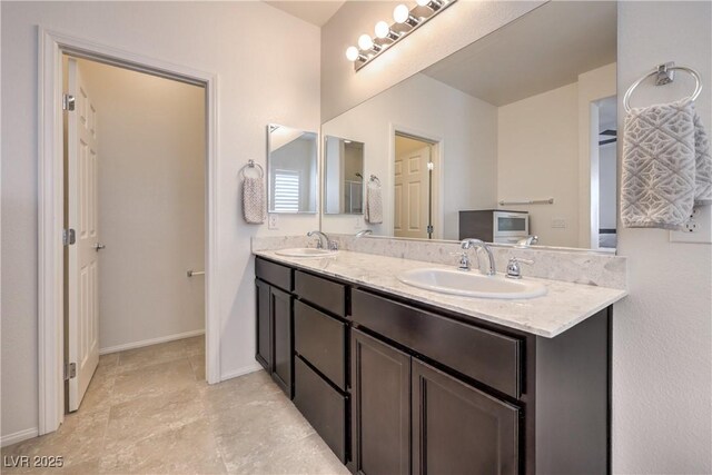 7948 Eastern Elk St, Las Vegas, NV 89149 - bathroom featuring double vanity and baseboards