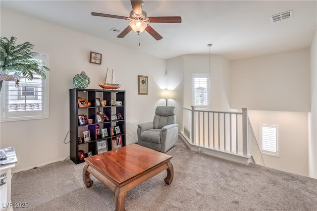 7948 Eastern Elk St, Las Vegas, NV 89149 - living area featuring carpet floors, an upstairs landing, and a ceiling fan
