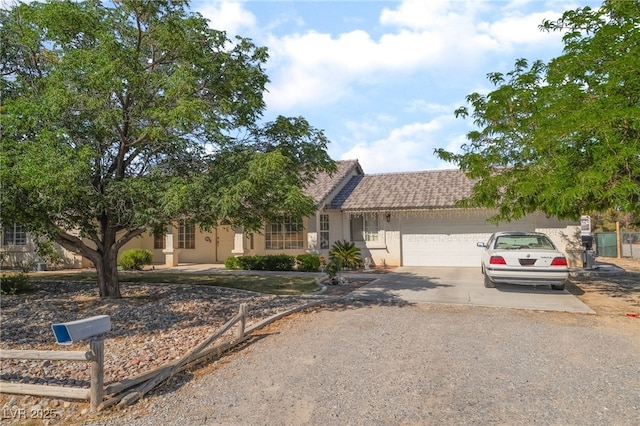 2230 Wagon Ave, Pahrump, NV 89048 - view of front facade featuring driveway, a garage, and stucco siding
