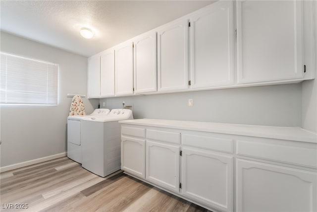2230 Wagon Ave, Pahrump, NV 89048 - washroom with cabinet space, washer and clothes dryer, and light wood-style floors