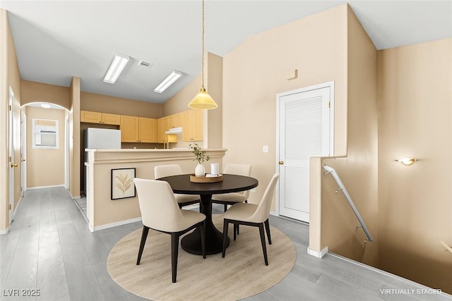 9338 Square Dance Pl Unit 101, Las Vegas, NV 89178 - dining room featuring vaulted ceiling and light wood-style flooring