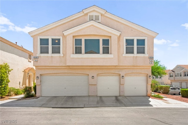 9338 Square Dance Pl Unit 101, Las Vegas, NV 89178 - multi unit property featuring a garage, driveway, and stucco siding