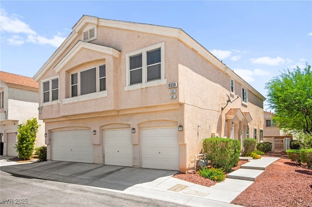 9338 Square Dance Pl Unit 101, Las Vegas, NV 89178 - townhome / multi-family property featuring stucco siding, a garage, and concrete driveway