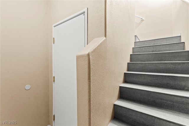 9338 Square Dance Pl Unit 101, Las Vegas, NV 89178 - staircase featuring a textured wall