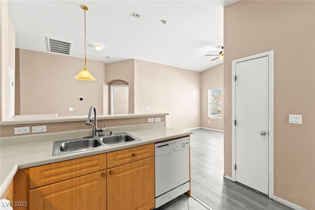 9338 Square Dance Pl Unit 101, Las Vegas, NV 89178 - kitchen featuring white dishwasher, ceiling fan, wood finished floors, light countertops, and pendant lighting