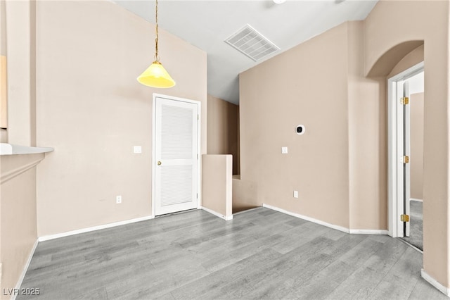 9338 Square Dance Pl Unit 101, Las Vegas, NV 89178 - unfurnished living room featuring wood finished floors and arched walkways