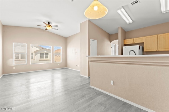 9338 Square Dance Pl Unit 101, Las Vegas, NV 89178 - unfurnished living room with lofted ceiling, ceiling fan, and light wood-style floors