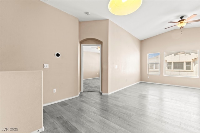 9338 Square Dance Pl Unit 101, Las Vegas, NV 89178 - unfurnished room featuring a ceiling fan, wood finished floors, vaulted ceiling, arched walkways, and a smoke detector