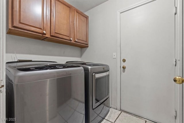 6292 Belgium Dr, Las Vegas, NV 89122 - laundry area with cabinet space, washer and clothes dryer, and light tile patterned floors