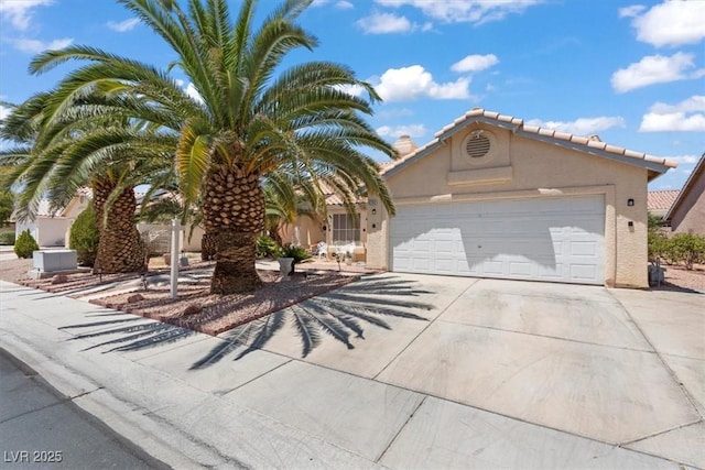 6292 Belgium Dr, Las Vegas, NV 89122 - view of front of house featuring concrete driveway, an attached garage, and stucco siding