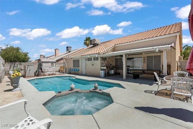 6292 Belgium Dr, Las Vegas, NV 89122 - view of swimming pool featuring a pool with connected hot tub, a patio, a fenced backyard, and outdoor dining area