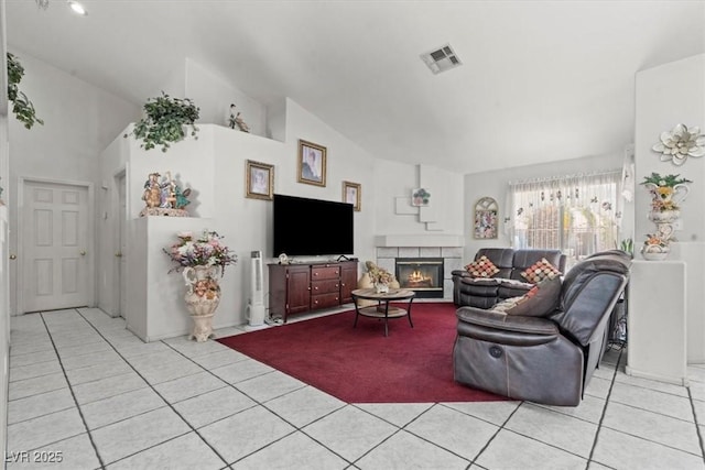 6292 Belgium Dr, Las Vegas, NV 89122 - living area featuring light tile patterned floors, a tile fireplace, and lofted ceiling