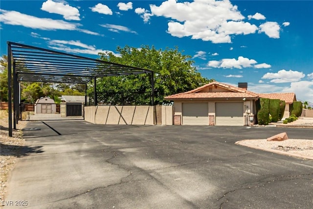 9660 W Ann Rd, Las Vegas, NV 89149 - view of car parking with a gate and asphalt driveway