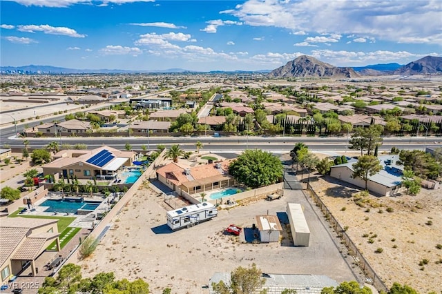 9660 W Ann Rd, Las Vegas, NV 89149 - aerial perspective of suburban area featuring a pool area and mountains