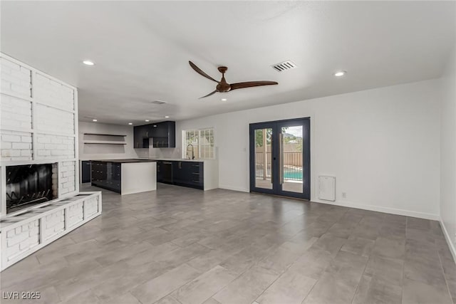 9660 W Ann Rd, Las Vegas, NV 89149 - unfurnished living room with ceiling fan, recessed lighting, and a fireplace