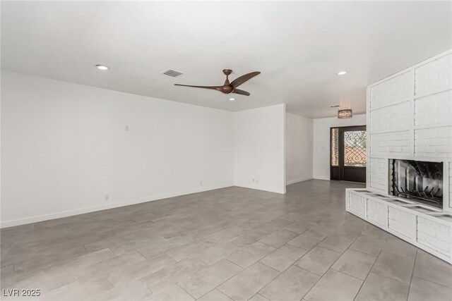 9660 W Ann Rd, Las Vegas, NV 89149 - unfurnished living room with a ceiling fan, recessed lighting, and a brick fireplace
