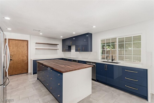 9660 W Ann Rd, Las Vegas, NV 89149 - kitchen featuring open shelves, wood counters, blue cabinetry, a kitchen island, and recessed lighting