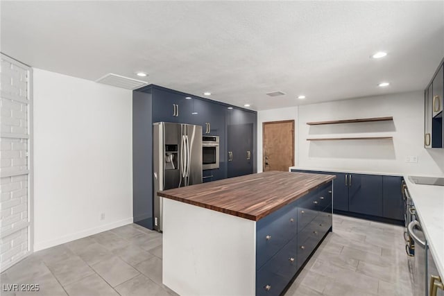 9660 W Ann Rd, Las Vegas, NV 89149 - kitchen with butcher block countertops, appliances with stainless steel finishes, open shelves, a center island, and blue cabinetry