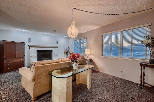 6213 Fairwood Ave, Las Vegas, NV 89107 - living room featuring dark carpet, a textured ceiling, and a fireplace