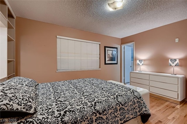 6213 Fairwood Ave, Las Vegas, NV 89107 - bedroom with light wood-type flooring and a textured ceiling