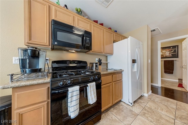 7701 W Robindale Rd Unit 274, Las Vegas, NV 89113 - kitchen with black appliances, light brown cabinets, light tile patterned floors, and light stone countertops