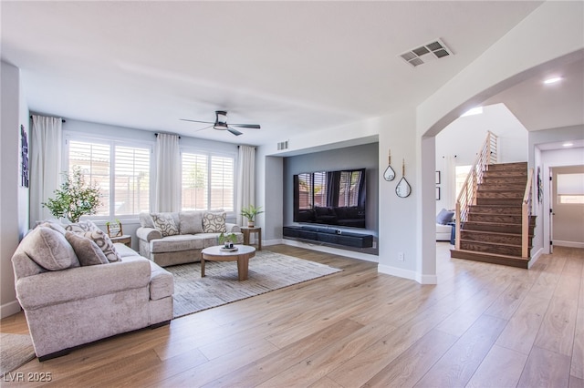 7445 Mezzanine View Ave, Las Vegas, NV 89178 - living room featuring a ceiling fan, light wood-type flooring, and stairway