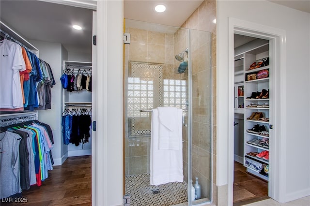 7445 Mezzanine View Ave, Las Vegas, NV 89178 - full bathroom featuring a walk in closet, a shower stall, wood finished floors, and recessed lighting