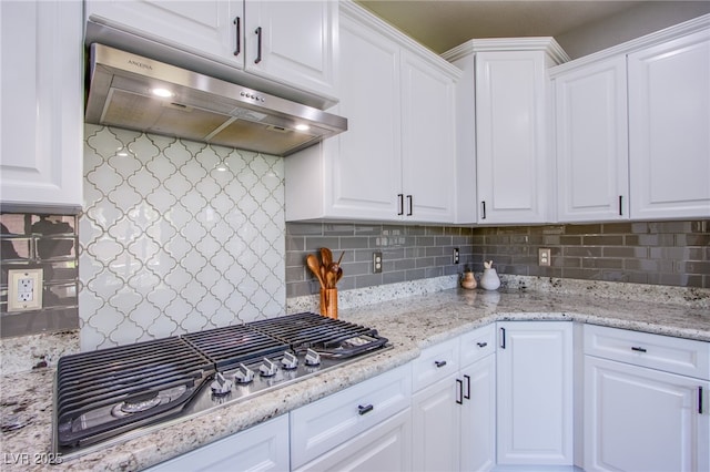 7445 Mezzanine View Ave, Las Vegas, NV 89178 - kitchen featuring under cabinet range hood, stainless steel gas stovetop, white cabinets, and decorative backsplash