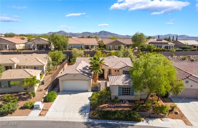 3029 Brownbirds Nest Dr, Henderson, NV 89052 - view of front of property with a residential view, concrete driveway, a mountain view, a garage, and stucco siding