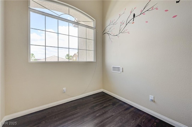 8565 Silver Coast St, Las Vegas, NV 89139 - spare room featuring baseboards and dark wood-type flooring