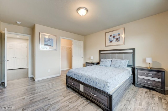 8565 Silver Coast St, Las Vegas, NV 89139 - bedroom featuring light wood-type flooring, a spacious closet, and a closet