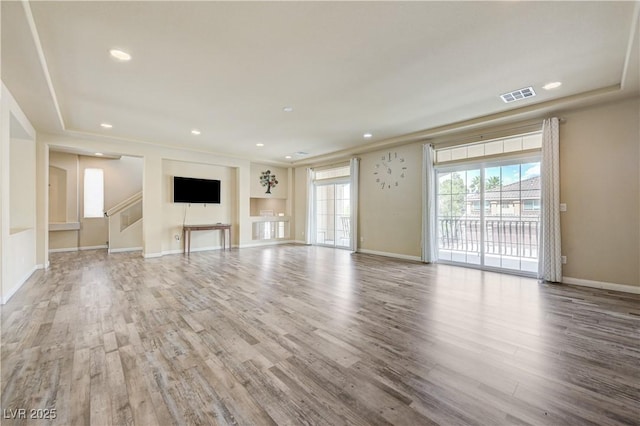 8565 Silver Coast St, Las Vegas, NV 89139 - unfurnished living room with wood finished floors, recessed lighting, and stairway