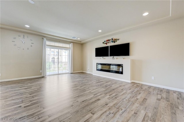 8565 Silver Coast St, Las Vegas, NV 89139 - unfurnished living room featuring light wood-style floors, a glass covered fireplace, and recessed lighting