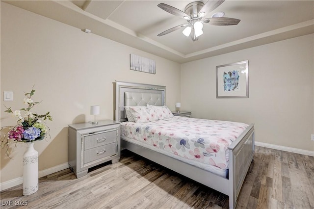 8565 Silver Coast St, Las Vegas, NV 89139 - bedroom featuring a raised ceiling, light wood-style flooring, and ceiling fan
