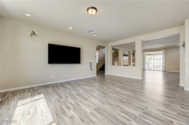 8565 Silver Coast St, Las Vegas, NV 89139 - unfurnished living room with light wood finished floors, stairway, and recessed lighting